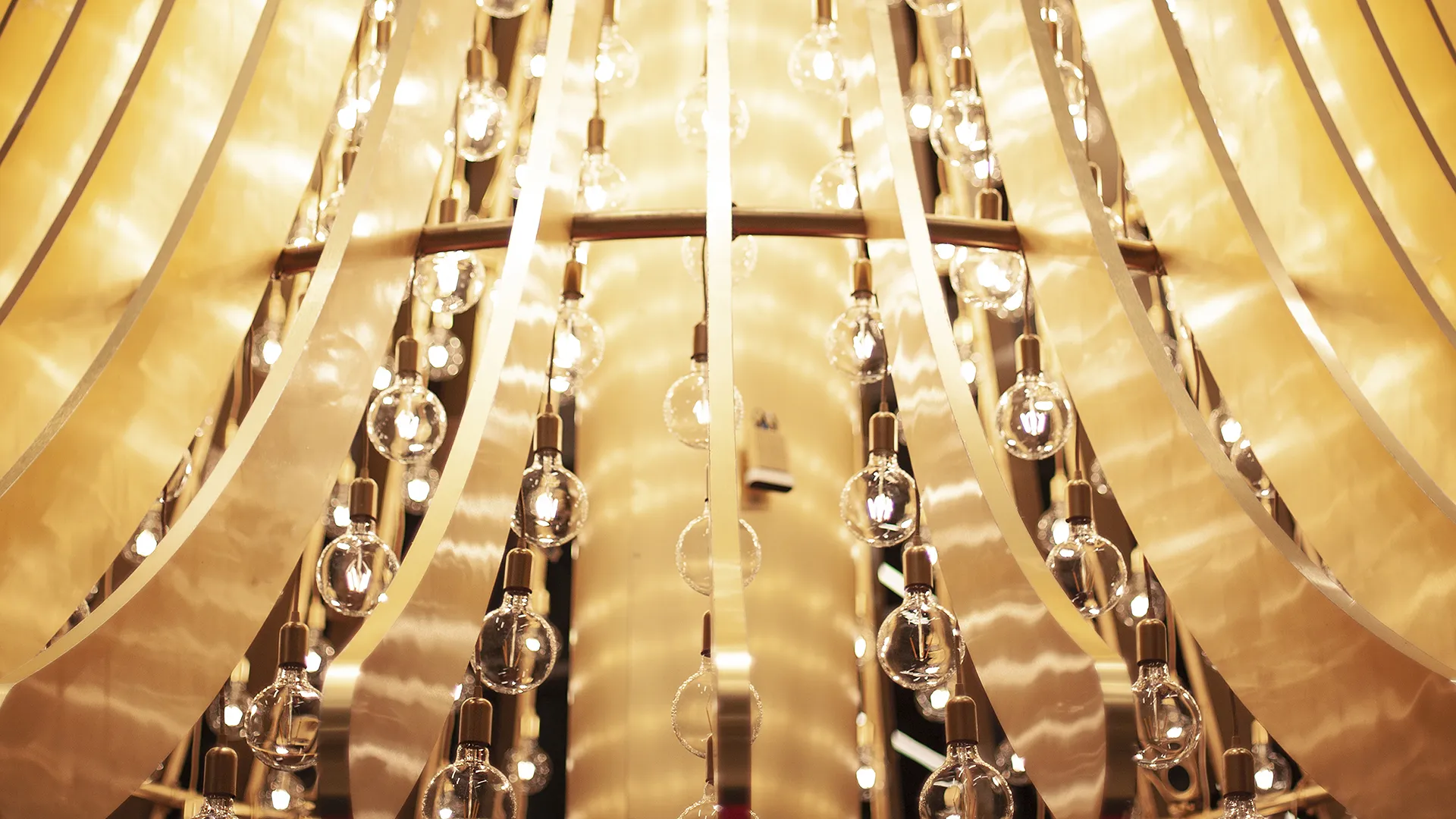 The Bells Grove — brass sculpture with hanging bulbs
